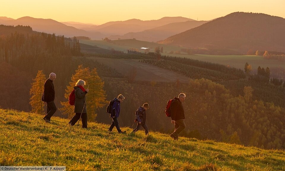 Gruppe von Wanderern läuft Berg hinunter